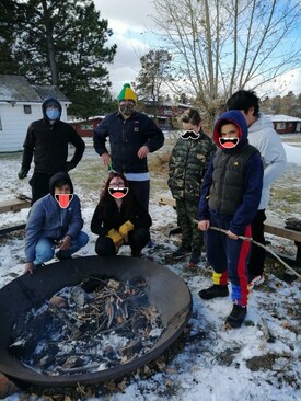 group of students standing around a fire pit
