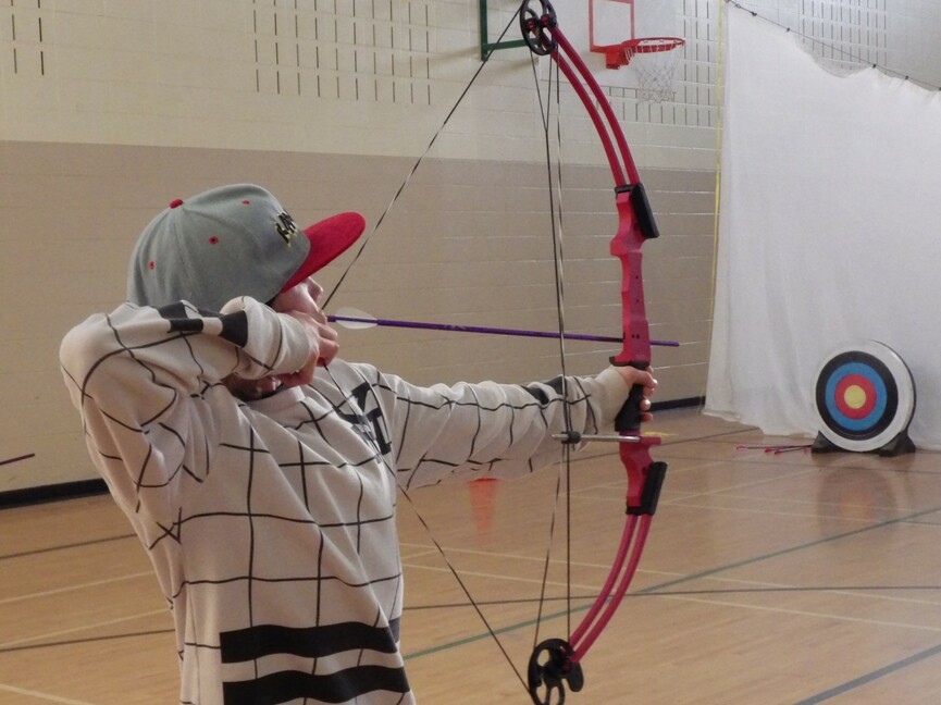 Student using a bow and arrow